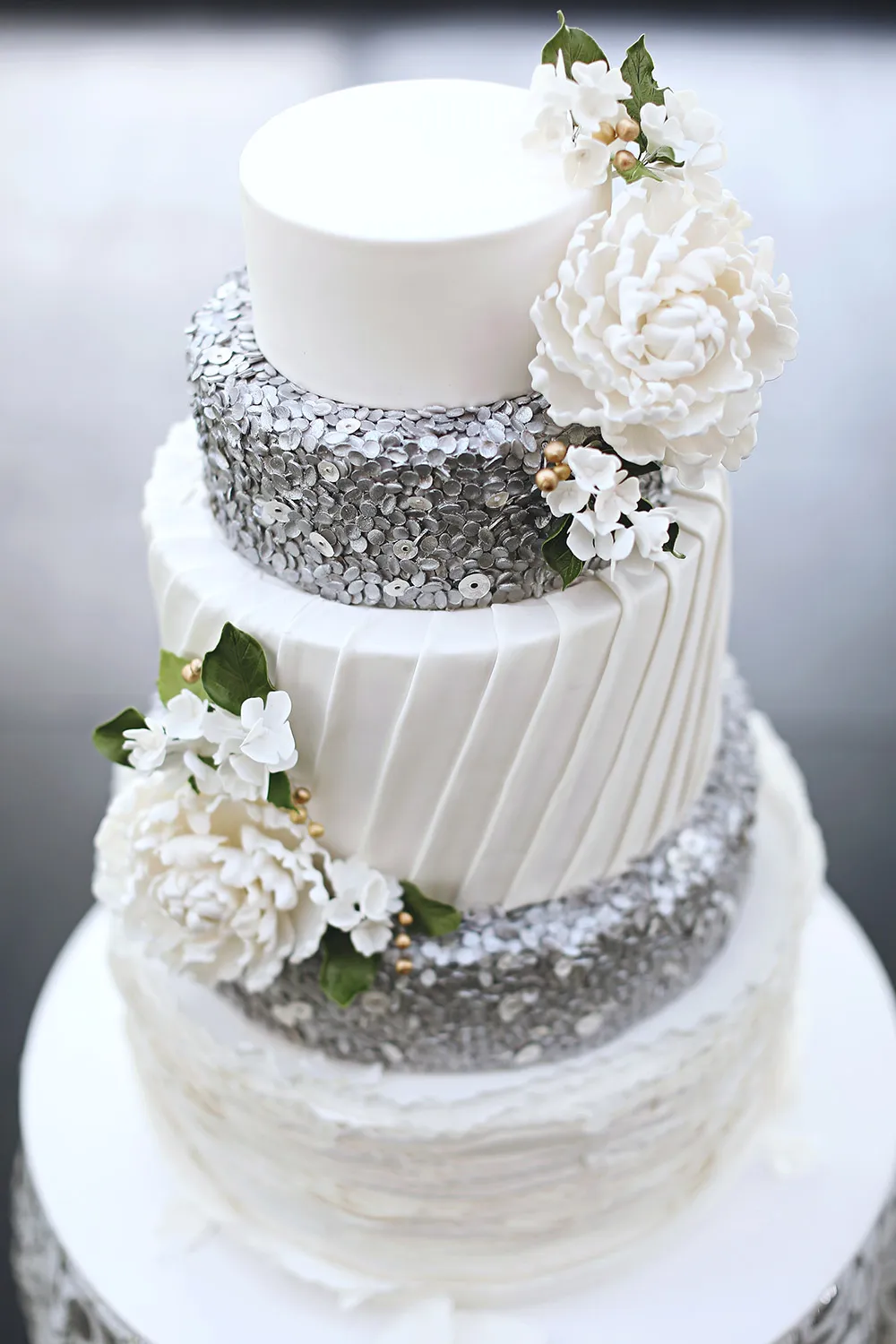 White and silver wedding cake by Miss Shortcakes. Photo by Axioo. theweddingnotebook.com