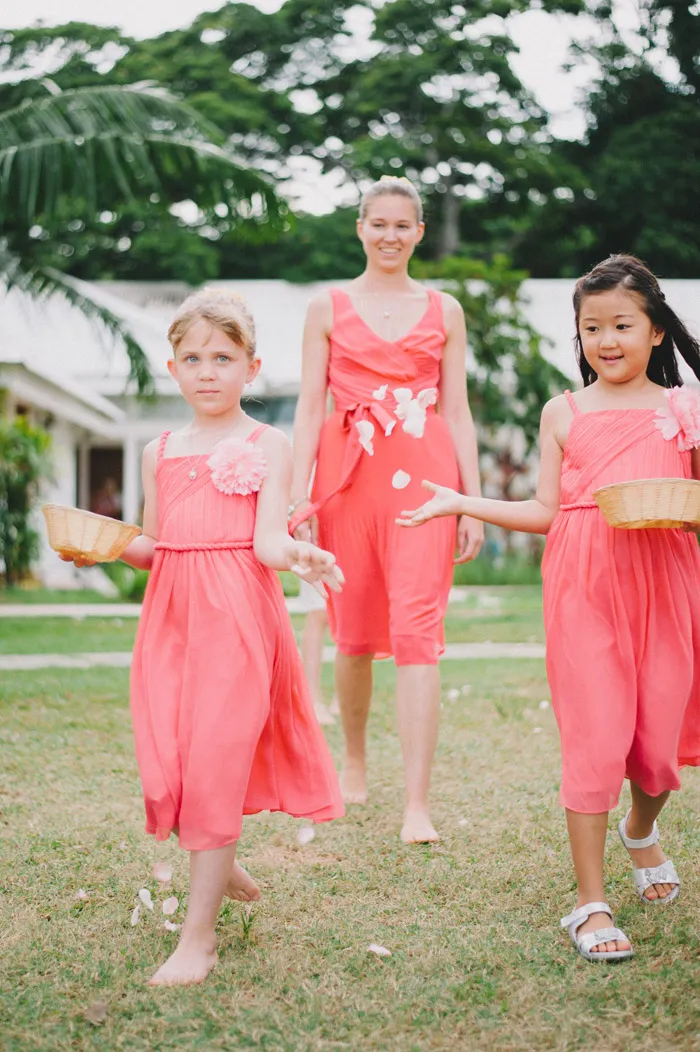 Flowergirls in coral. Photo by Andri Tei Photography. theweddingnotebook.com