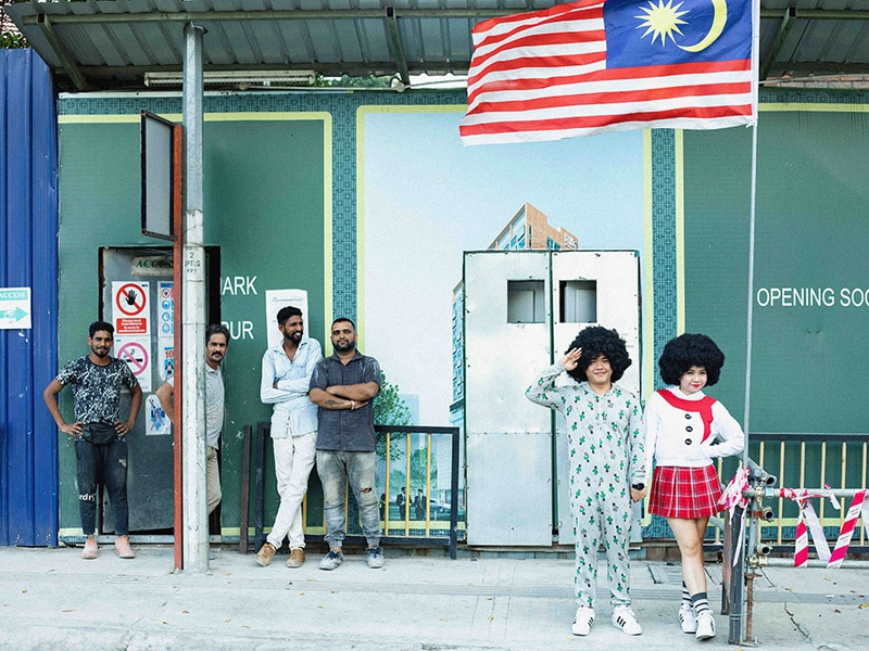 Couple Wears Big Afro Wigs for Their Bridal Portraits Taken at Petaling Street Kuala Lumpur