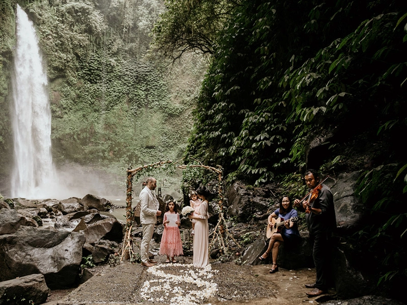 Renewing Their Vows In An Intimate Family Affair at Nungnung Waterfall Bali For Their 10th Anniversary